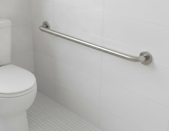 Angled stainless steel grab rail on a tiled bathroom wall